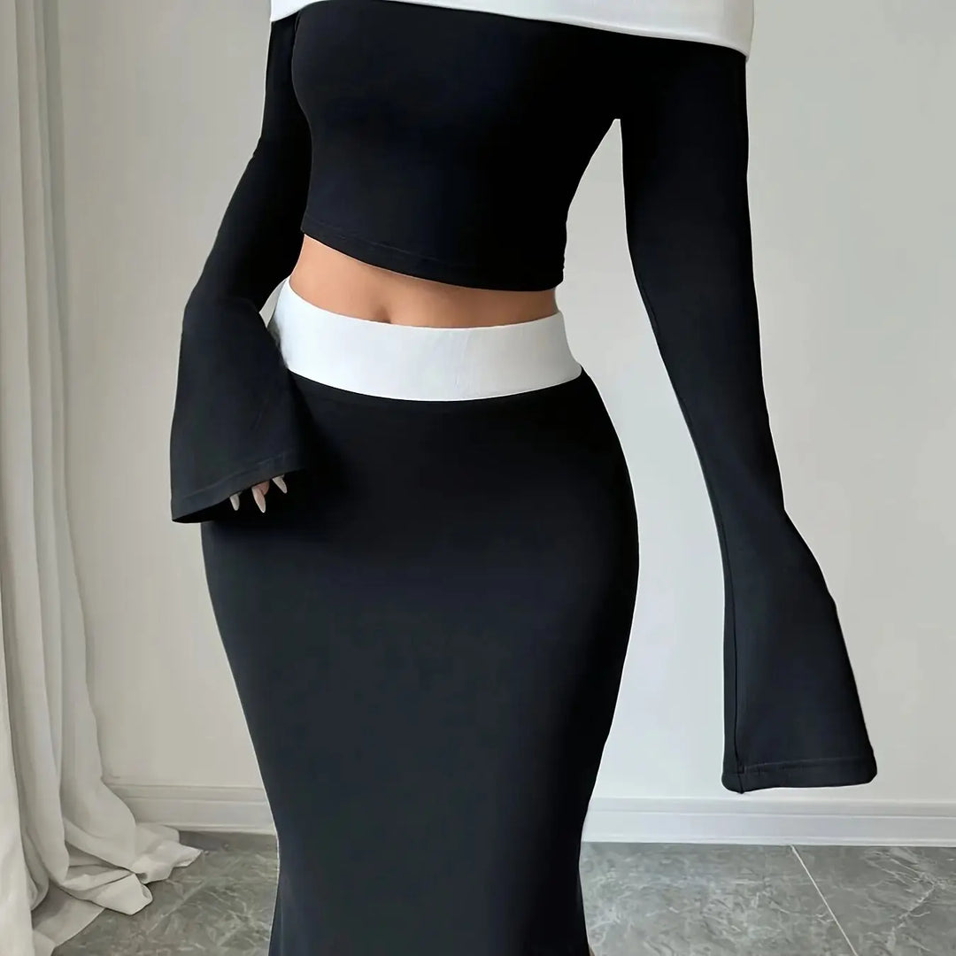 Black off-shoulder crop top with white band, flared sleeves, and mermaid skirt