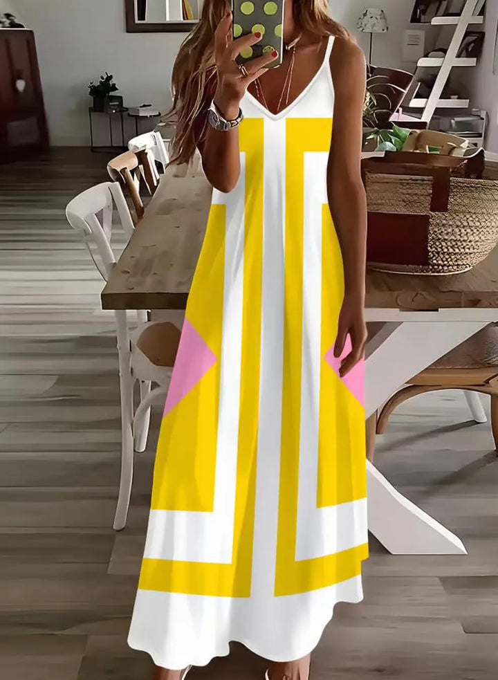 Person wearing a yellow and white dress with geometric patterns in a dining room.