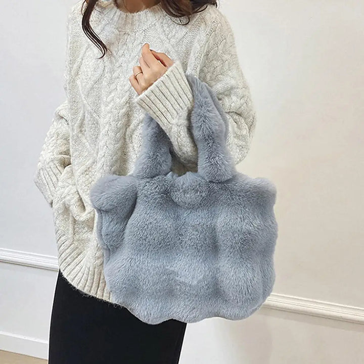 Light gray faux fur bucket handbag with short handles and rounded shape