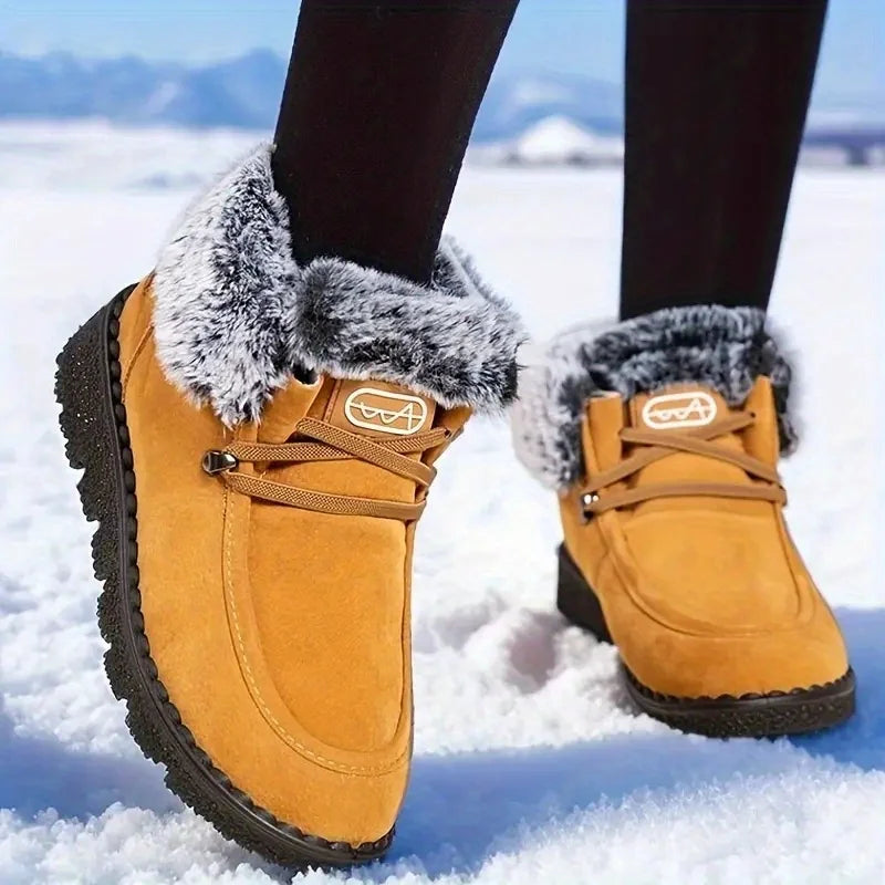 Women's tan lace-up snow boots with faux-fur cuffs and treaded sole