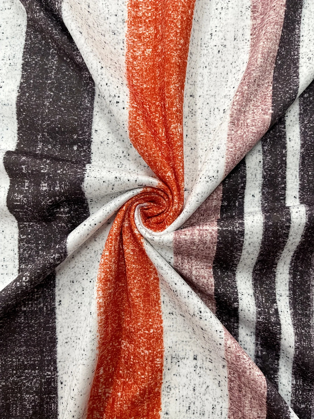 Close-up of striped fabric with black, white, and orange colors.