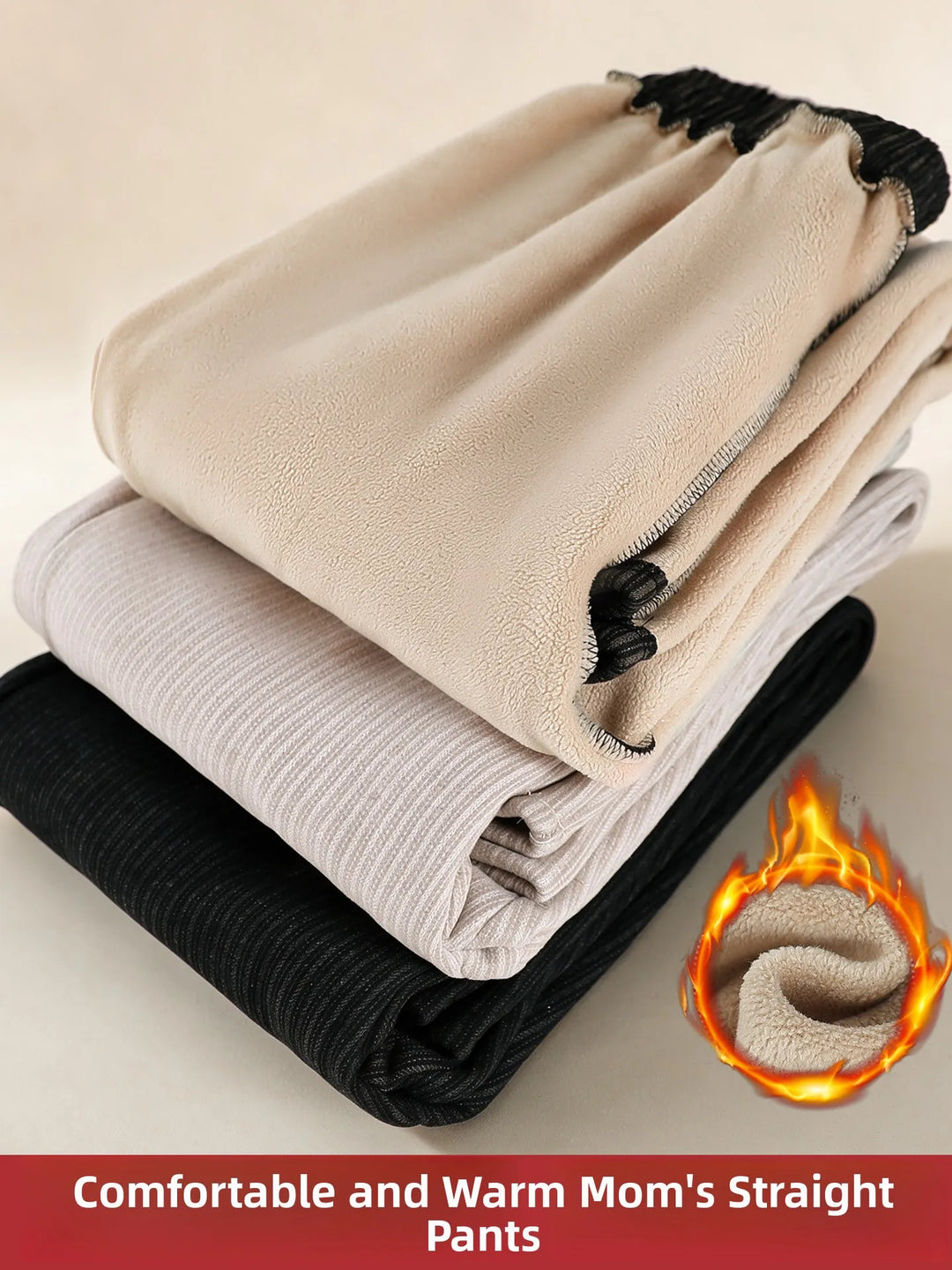 Three pairs of folded warm-weather pants stacked diagonally, shown in beige, light gray, and black. The top pair has a soft fleece-like texture with black drawstrings.