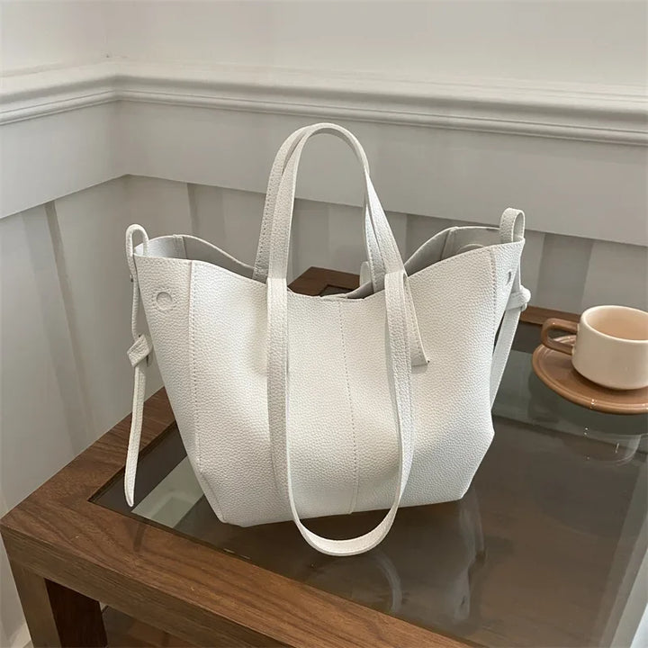 White tote bag on a glass table with a neutral background