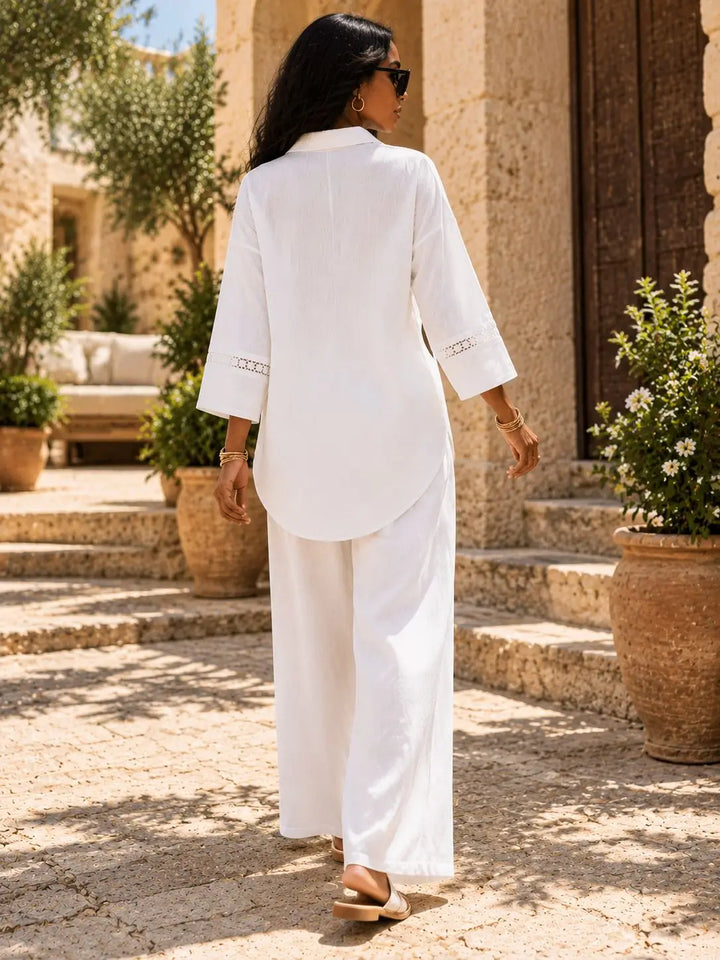 Ivory pant set, back view showing the shirt's curved hem and wide-leg trousers