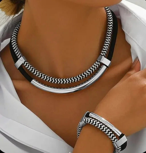 Necklace and bracelet set with black and white pattern worn by a person
