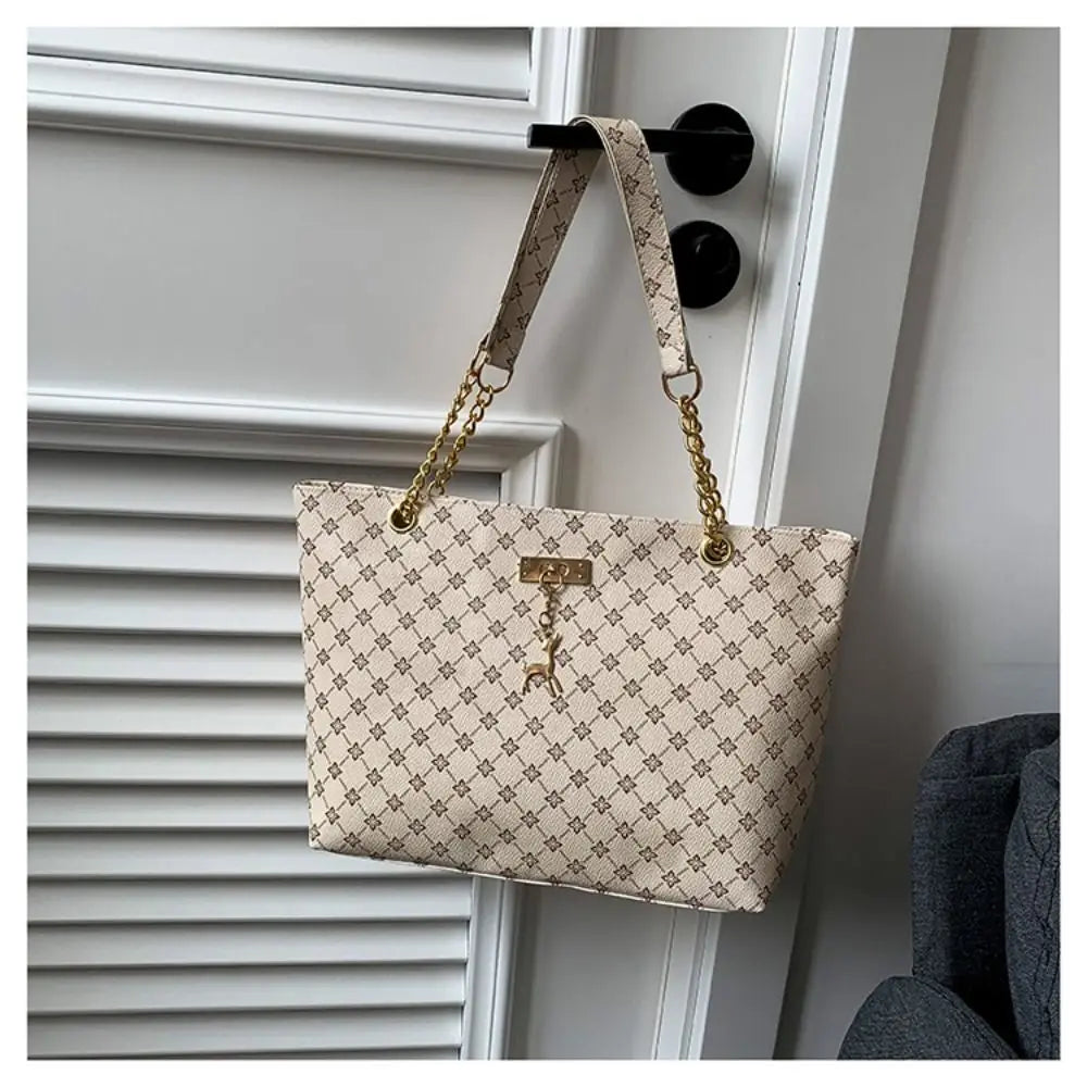 Large patterned bucket tote bag with gold chain handles and top clasp, light beige
