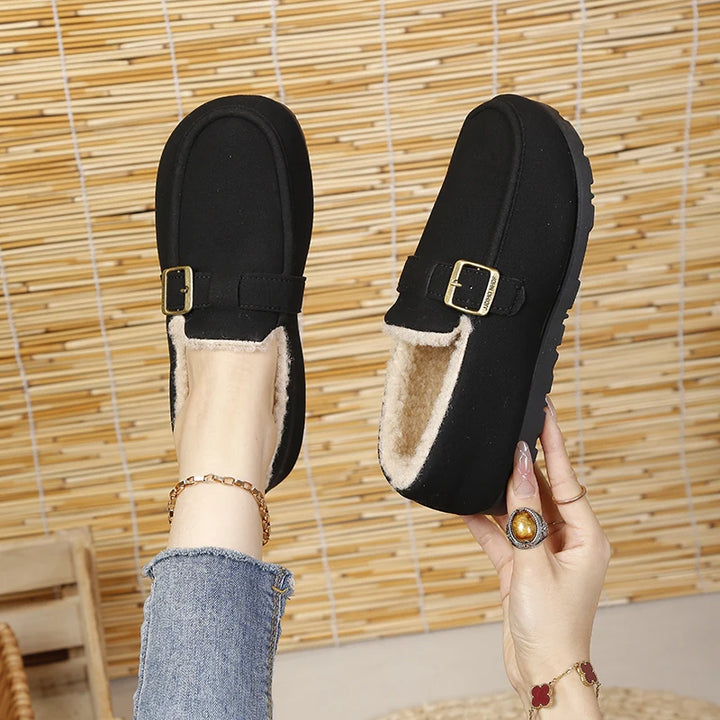 Black slip-on loafer with gold buckle and short plush lining