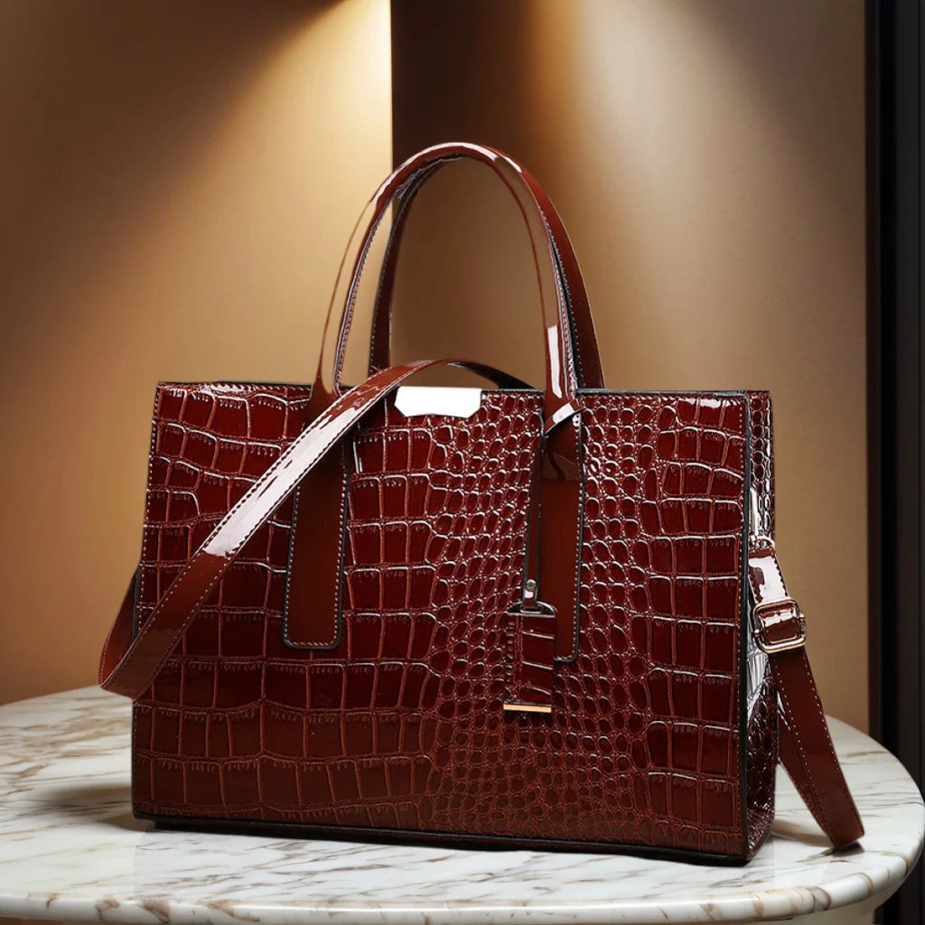 Crocodile-pattern leather tote handbag with top handles and shoulder strap, deep brown.
