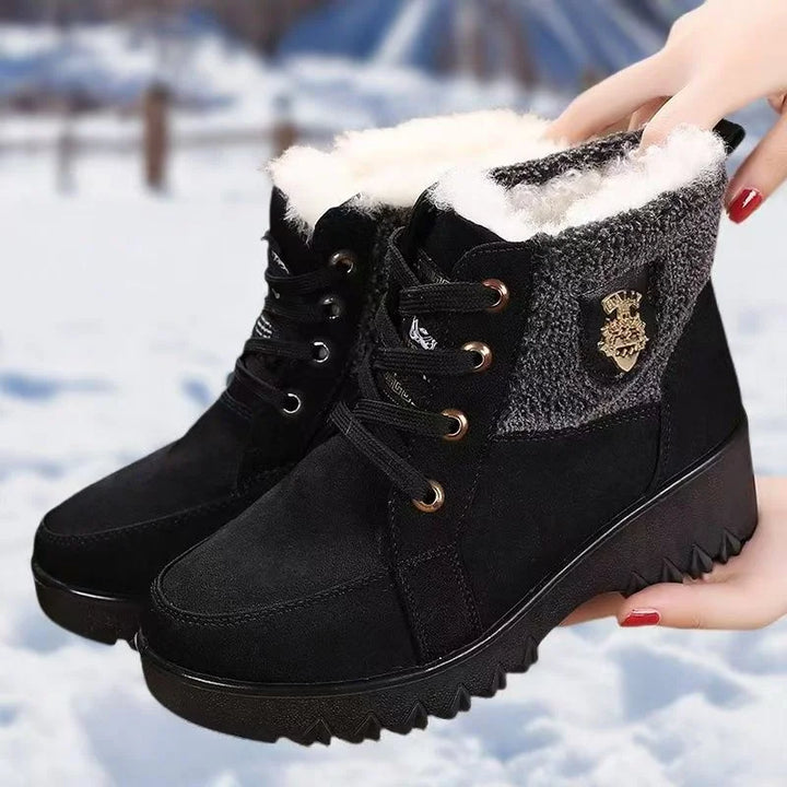 Women’s black lace-up winter boots with faux-fur lining and gold-toned lace hardware
