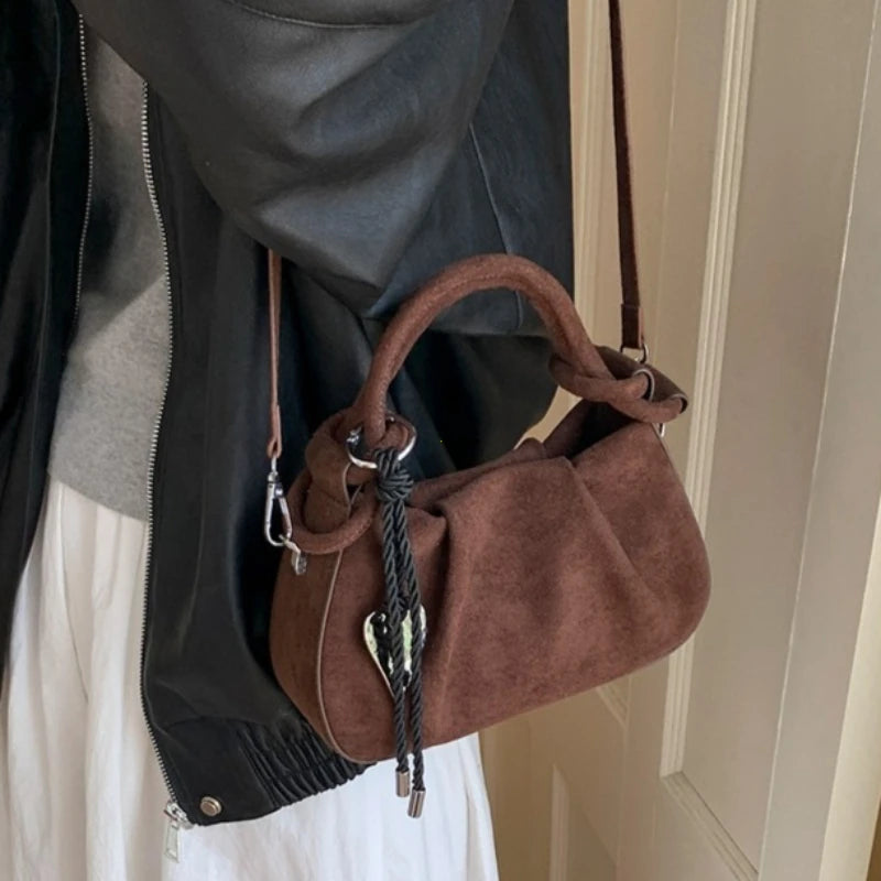 Brown suede mini hobo bag with short handles, braided cord, and long crossbody strap.