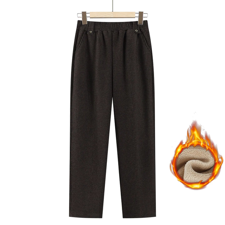 Dark brown ribbed knit cropped pants with an elastic waistband, shown hanging on a wooden hanger against a white background, with a flame-and-sheer-fabric graphic indicating warm lining.