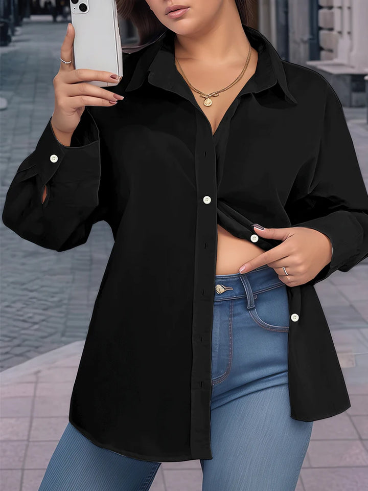 Person wearing a black shirt and blue jeans outdoors.