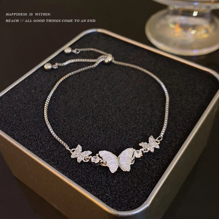 Silver-tone beaded bracelet with star charms and white oval center