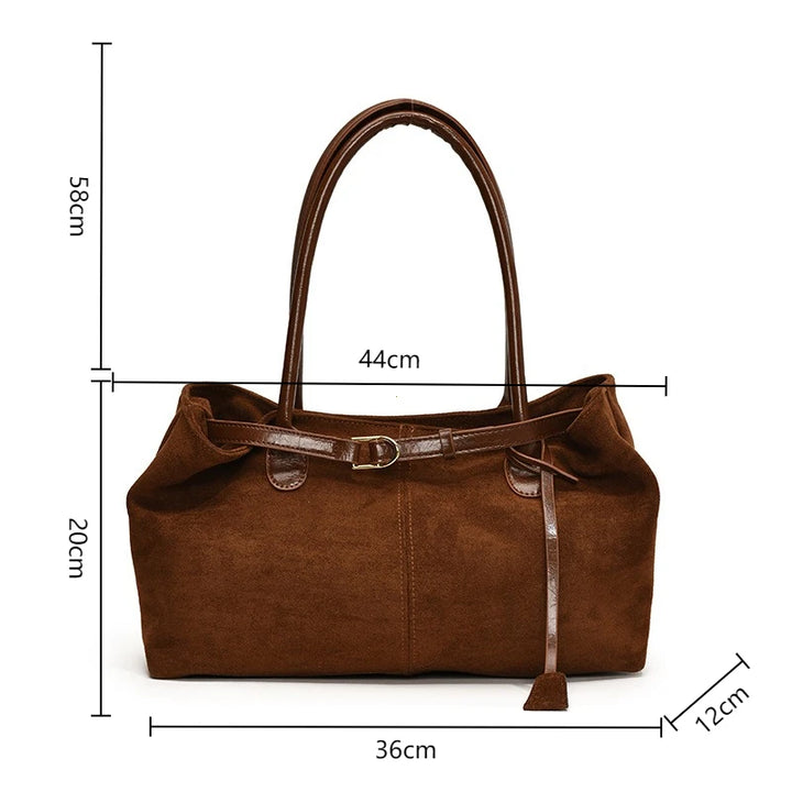 Women’s suede tote bag in brown, front view with hanging tassel strap.