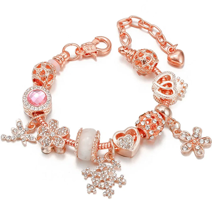 Rose gold charm bracelet with pink crystal beads, flower accents, and dangling snowflake charm