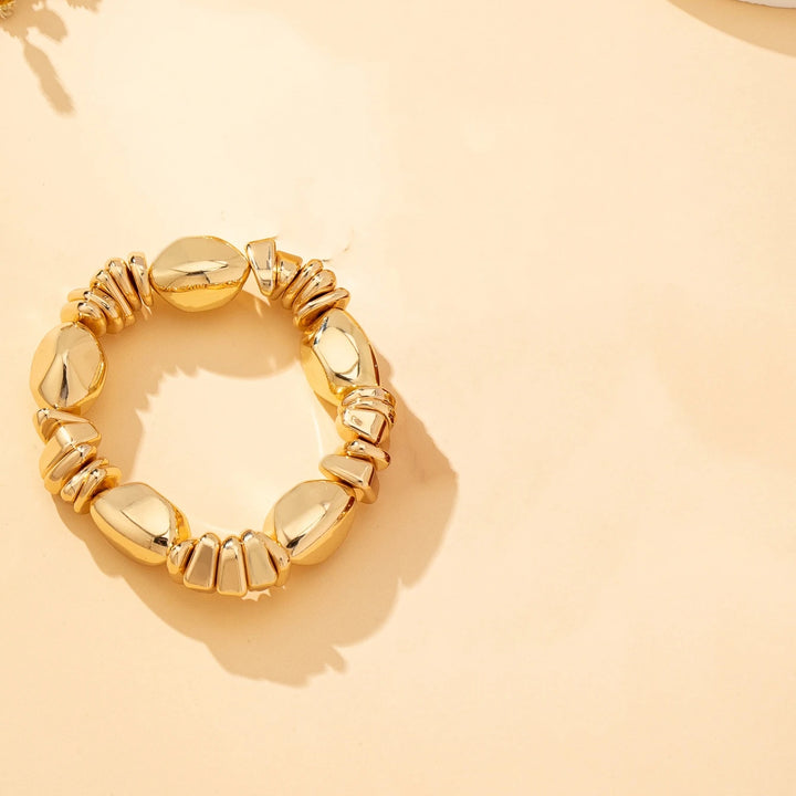 Gold-tone acrylic bead bracelet with metallic oval beads and chunky link accents