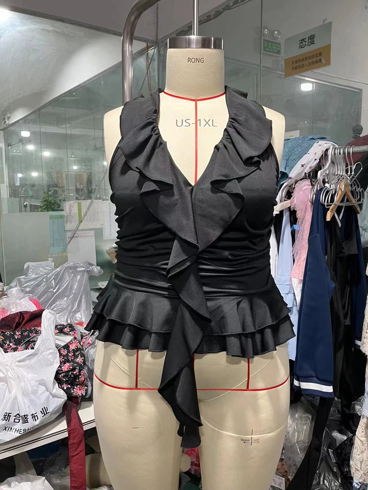 Black ruffled top on a mannequin in a clothing store setting