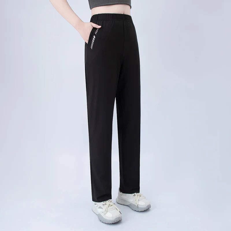 Black wide-leg pocket pants with elastic waist and side graphic detail