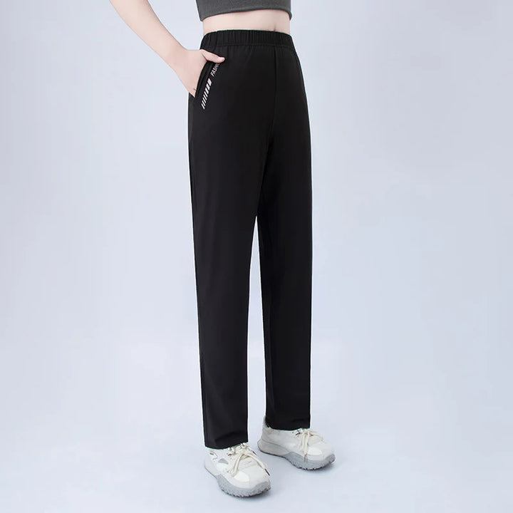 Black wide-leg pocket pants with elastic waist and side graphic detail