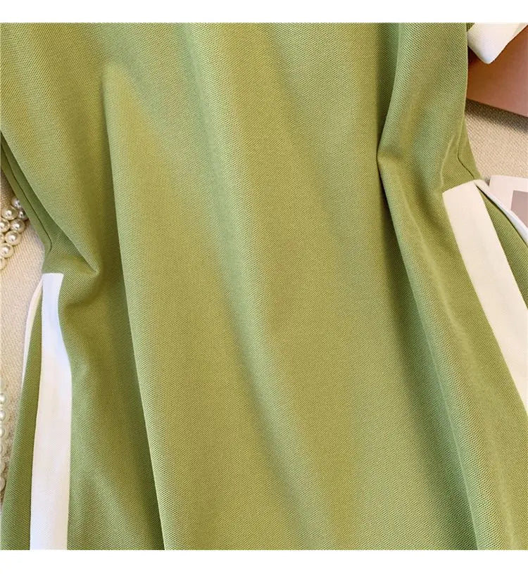 Green polo dress close-up of smooth fabric and white side trim