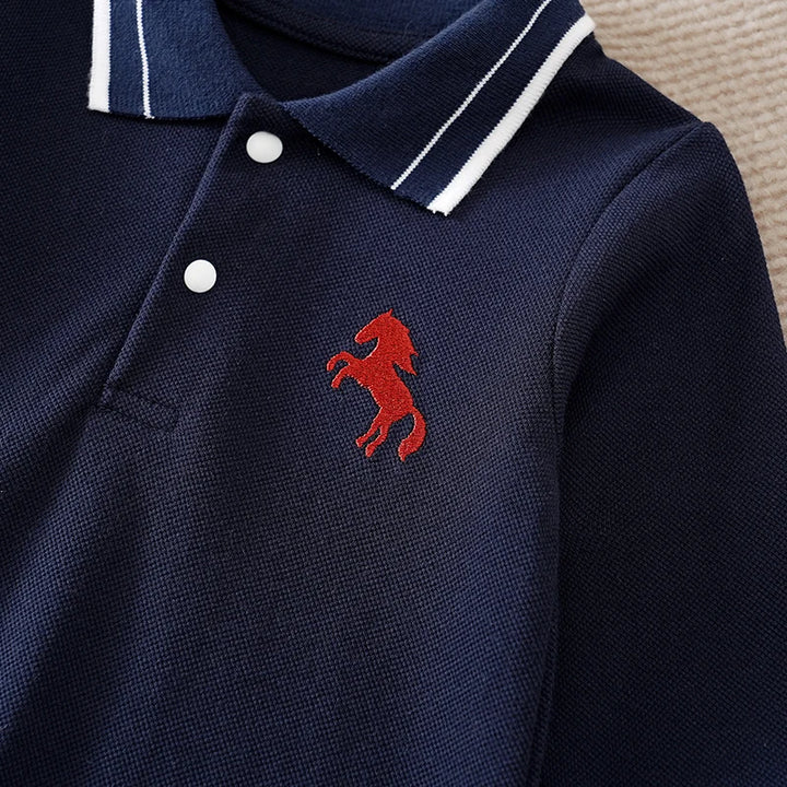 Navy blue polo shirt with a red embroidered horse logo on a neutral background