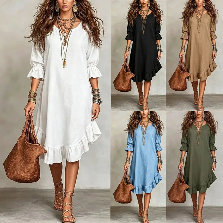 Woman in a white dress holding a brown bag, surrounded by other dresses in black, beige, blue, and green.