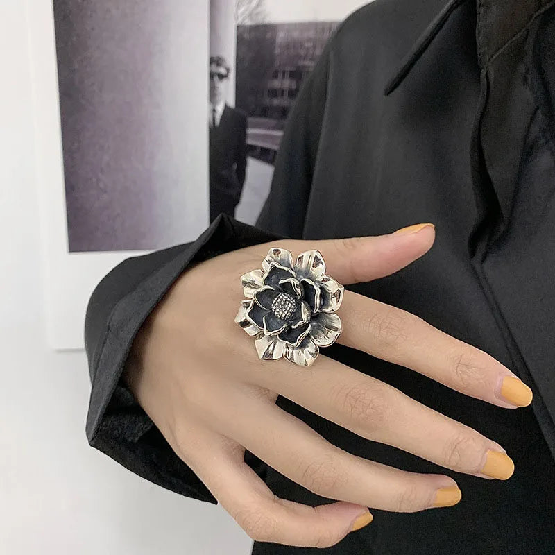 925 sterling silver statement flower ring with dark center bead on hand