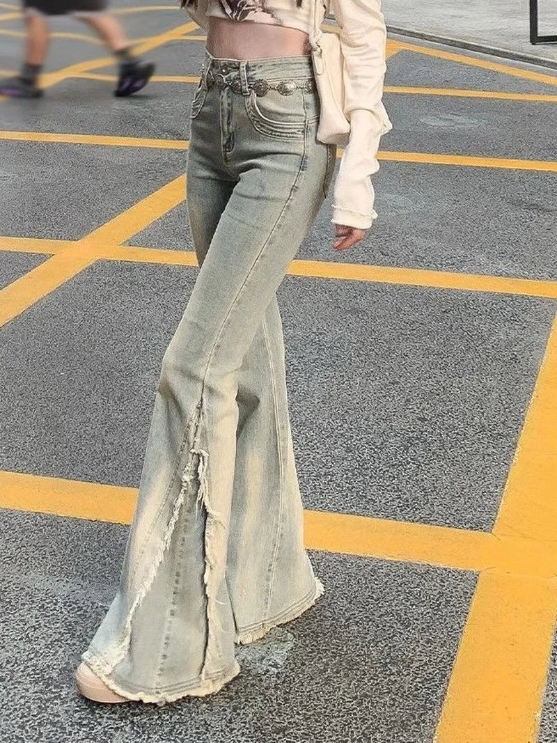 Light blue high-waist flared jeans with distressed leg panels and raw cut hem
