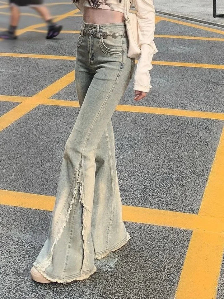 Light blue high-waist flared jeans with distressed leg panels and raw cut hem