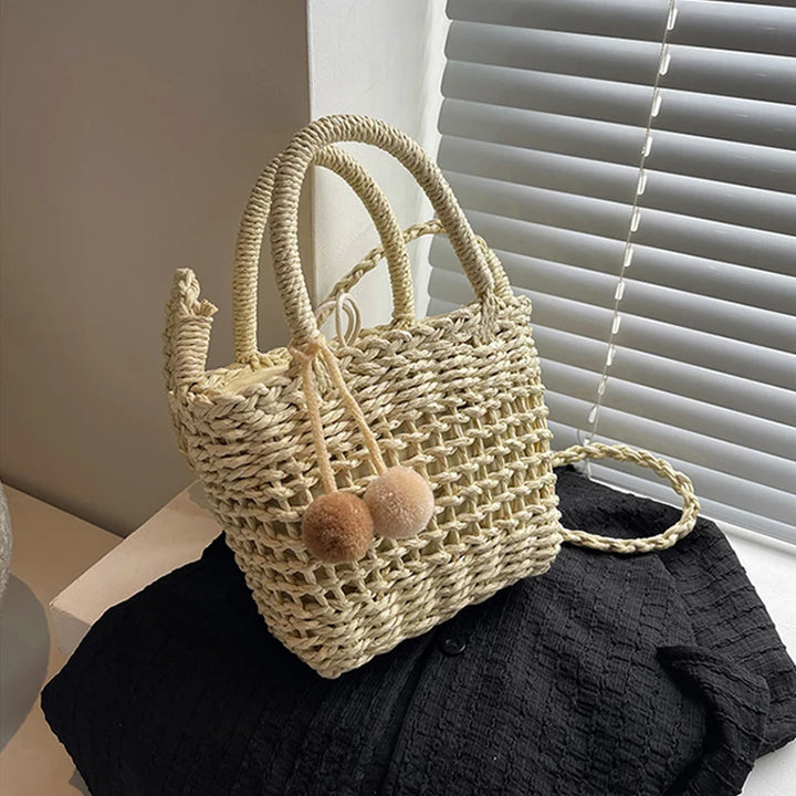 Khaki and beige knit straw bucket crossbody bag with pom-pom charms and rope handles