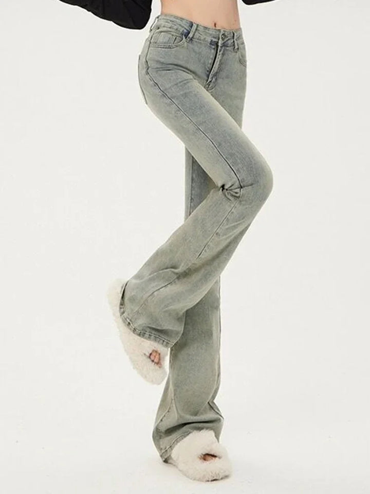 Light gray flared jeans worn by a person on a white background