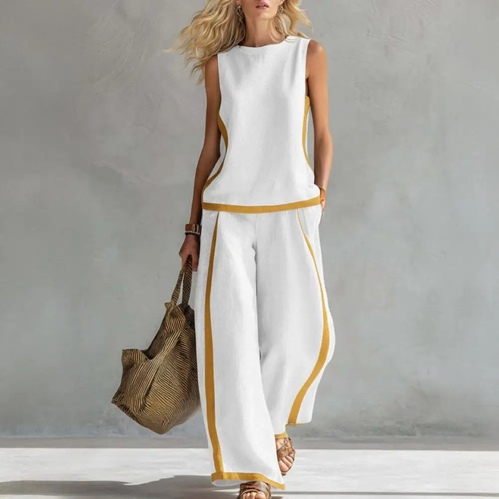 White sleeveless vest and wide-leg pants set with gold trim