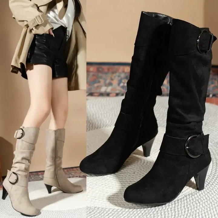 Two pairs of boots, one beige and one black, on a textured surface.