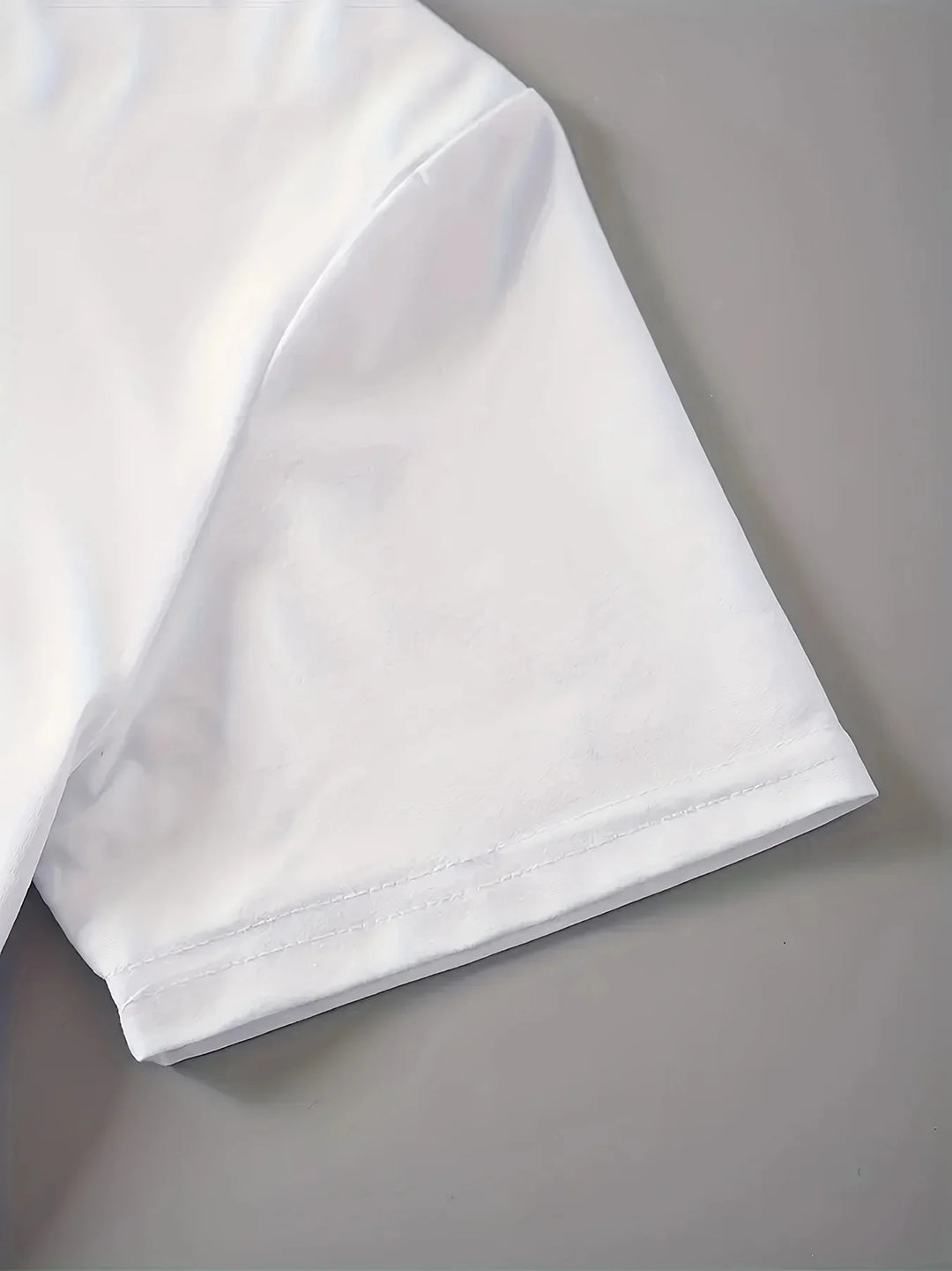 White tee sleeve cuff hem close-up with neat stitching