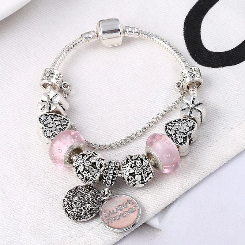 Silver-tone charm bracelet with pink glass beads and heart nameplate pendant