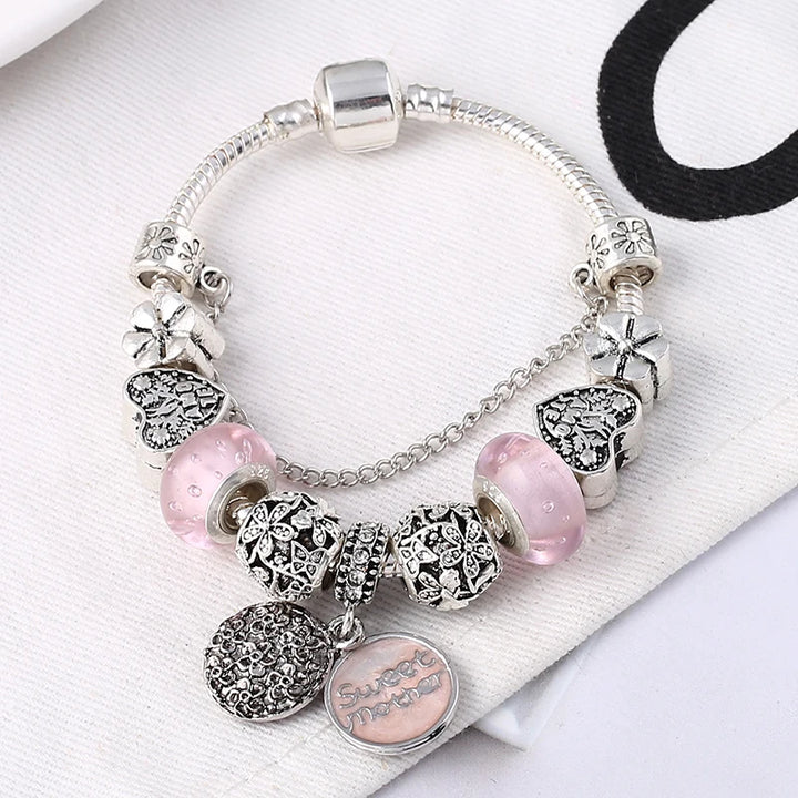 Silver-tone charm bracelet with pink glass beads and heart nameplate pendant