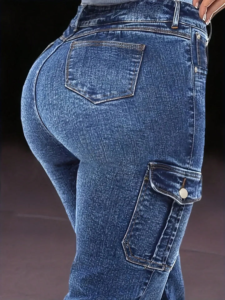 Close-up of dark blue denim jeans: back pocket and side cargo pocket with metal rivet trim.