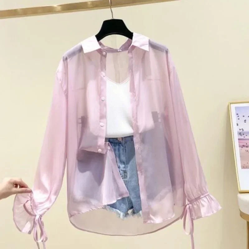 Pink sheer button-up long sleeve shirt with ruffled cuffs and drawstring hem