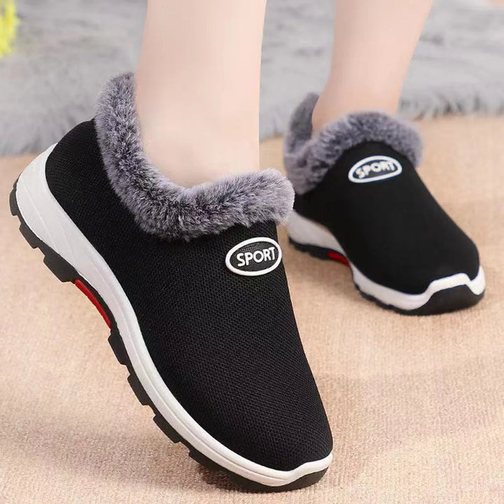 Women’s black slip-on plush sneakers with gray fuzzy collar and white rubber sole