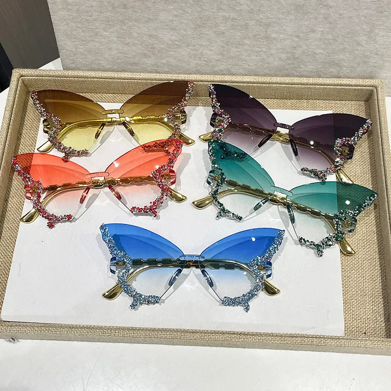 Set of colorful butterfly-style sunglasses in a box