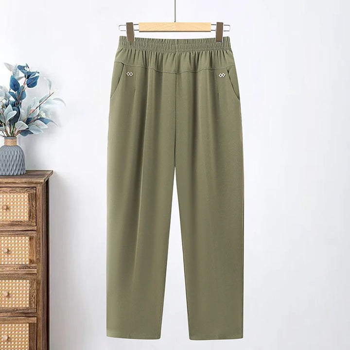 Olive green loose pants with an elastic waist and angled pockets