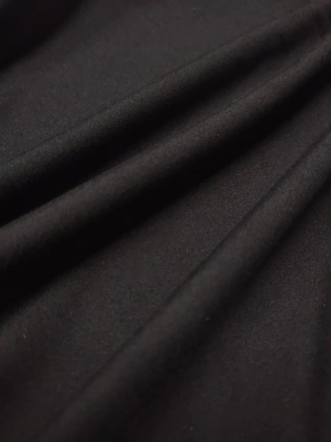 Close-up of dark gray fabric with folds