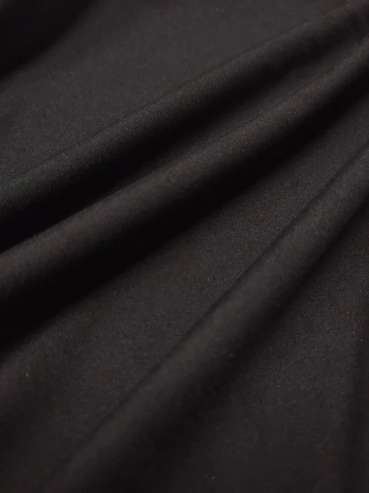 Close-up of dark gray fabric with folds