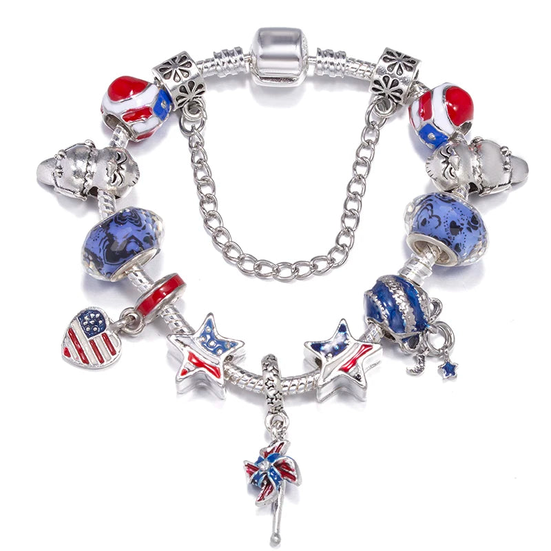 Silver charm bracelet with blue and red patriotic charm beads, stars, and a hanging flower