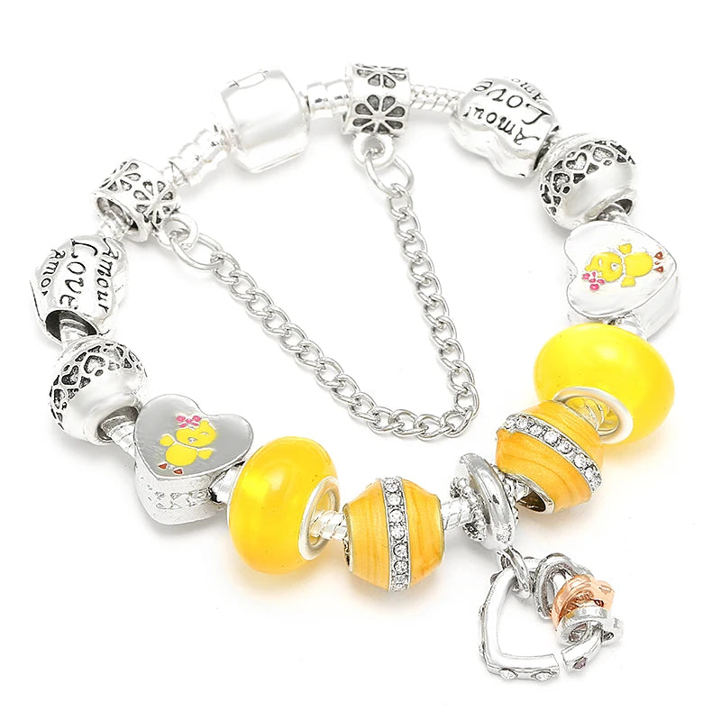 Silver-tone bracelet with yellow bead charms, small animal motifs, and heart lock charm