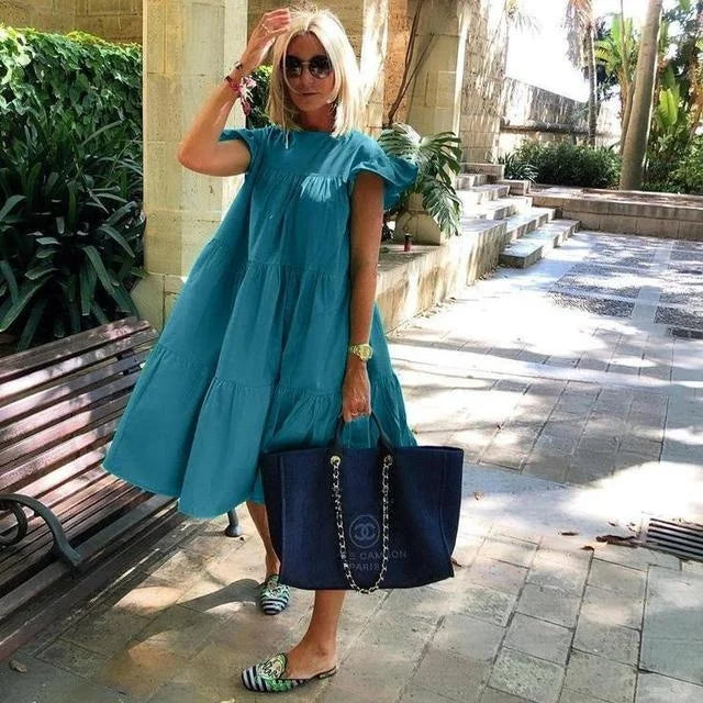 Teal-blue tiered midi dress with short puff sleeves and gathered yoke