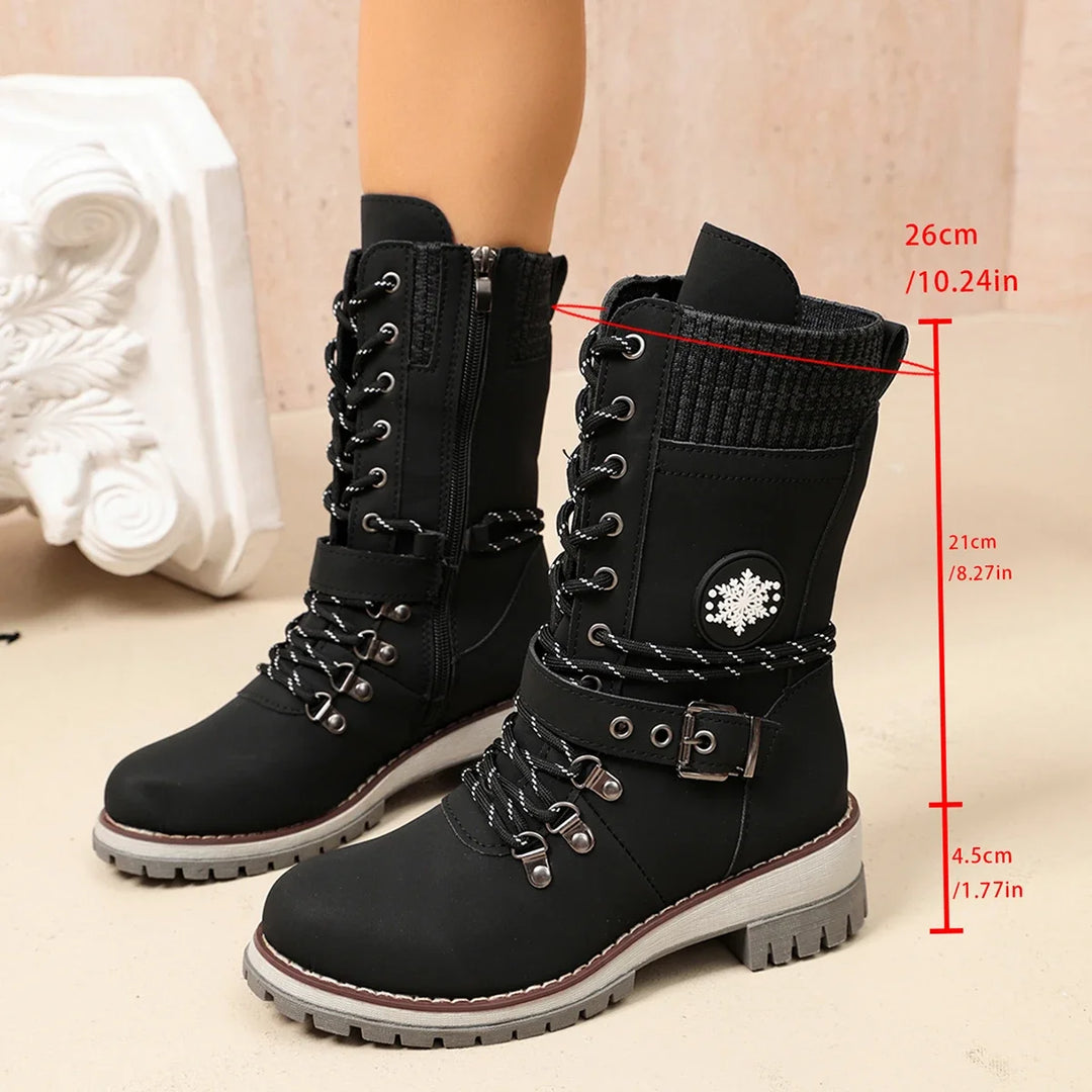 Women’s winter boots in black with lace-up design, side knit panel, and rugged sole.