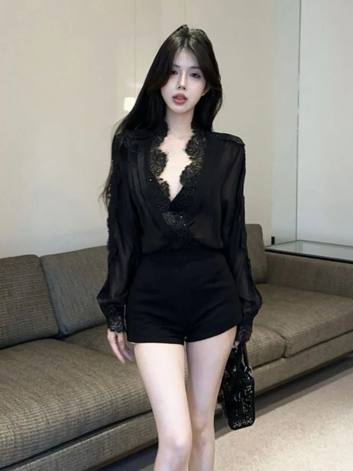 Woman wearing a black lace top and shorts in an indoor setting