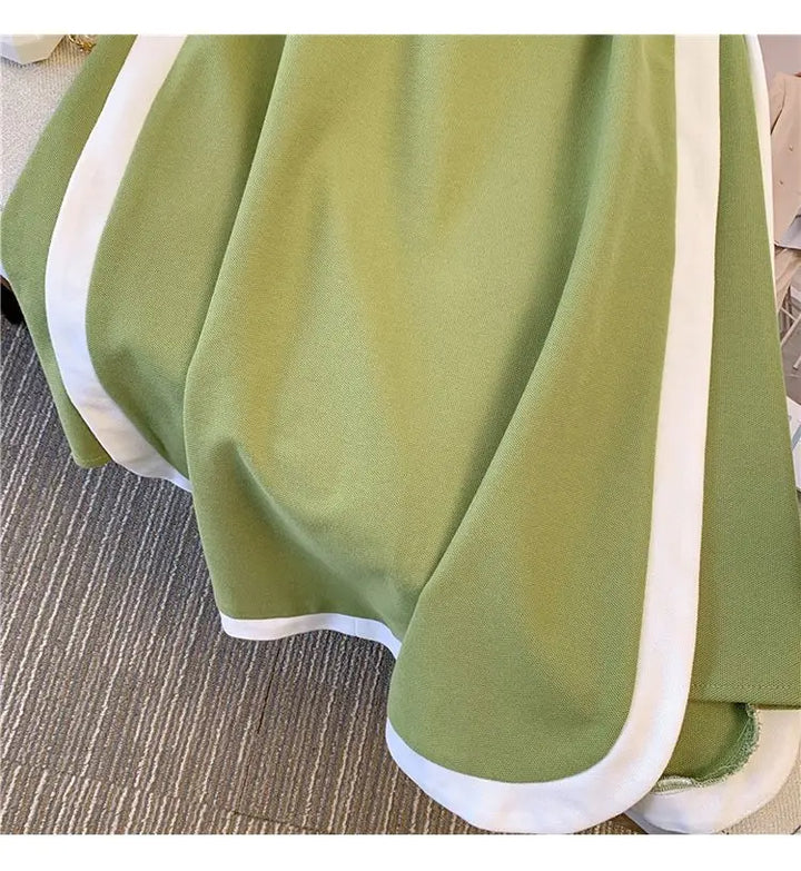 Green polo dress hem and side-panel trim in white