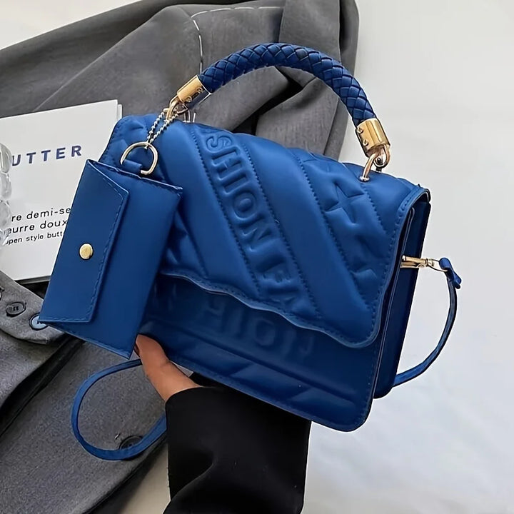 Women’s quilted crossbody bag in blue with braided handle strap and mini pouch